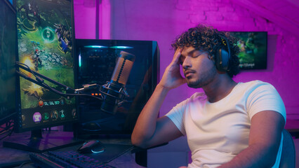 Emotional Arabian Latino man computer gamer cyber sport gaming streamer e-sport fail stressed player loss shout microphone male video game play stream upset guy influencer home online blogger addict