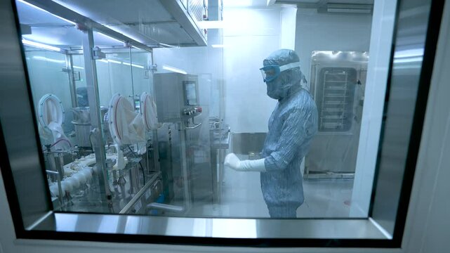pharmaceutical worker in industry vaccine drug glass vial ampoules in a medicine factory creative view of small vials for manufacturing small glass injection moving in a pharma equipment machinery