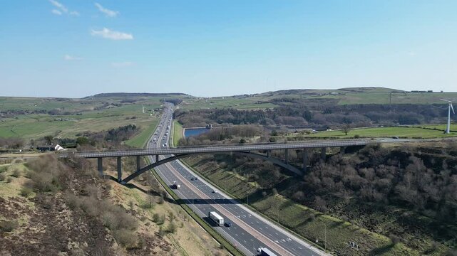 Pull-back drone shot of the Scammonden Bridge over the M62 Motorway in Huddersfield, England, UK