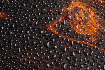 Water Drops on Surface of Cedar Wood Board Torched with Fire and Treated with Ting Oil for Protection From Outdoor Environment 