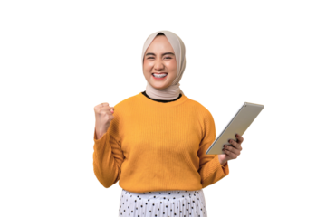 Beautiful excited Asian girl wearing hijab using digital tablet, raising fist, celebrating success isolated on transparent background