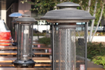 Outdoor heating lamps warming a restaurant patio area in autumn
