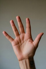 someone is holding their hand up in the air with their fingers