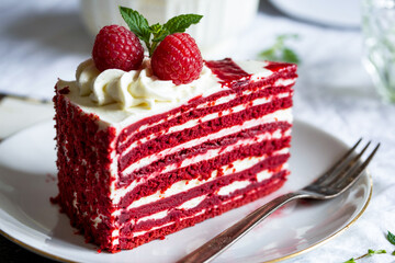 Delicious Red Velvet Cake Slice Garnished With Fresh Raspberries And Mint
