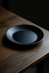 there is a black plate on a wooden table with a black background