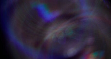 Bokeh glow. Defocused circling fantasy. Blue bright sparkling blinking particles motion on dark black blurred abstract light background.