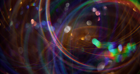 Magical Christmas. Defocused light flares. Sparkling green color particles lens flash motion on blurred background with bokeh effect.