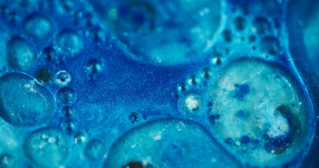 Cosmic shimmer. Defocused magic blue. Colorful flickering gleaming blinking paint texture motion on abstract blurred bokeh light background.