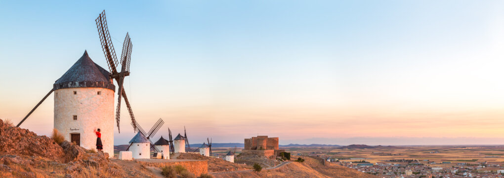 Woman near windmills on the Don Quixote route, Spain