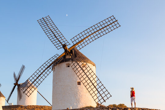 Tourist near windmills on the Don Quixote route, Spain