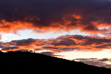 Fototapeta premium Sunset background. Dramatic majestic sunset landscape. Sky with clouds in the background of the light of the dawn sky. Sunset with clouds in various shapes. costa rica