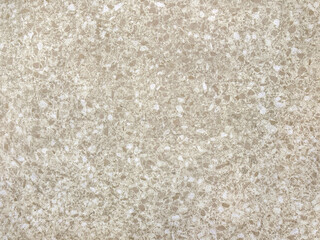 Close up of colorful cream beige terrazzo granite tiles texture. Terrazzo is increasingly being used in contemporary edgy and stylish interior as wall or floor finishing.