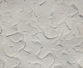 Close up of decorative 3d white stucco textured paint on a wall or panel, in random curly curves. White rough uneven surfaces. Suitable for bump, paint, or graphic background. Seamless background text