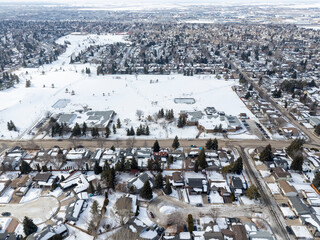 Snowy cityscape with houses and a park