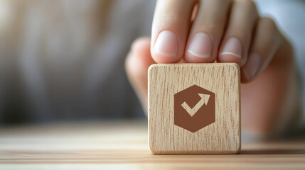 A hand holds a wooden block with a risk icon overlay, symbolizing hands-on management of business risk strategies