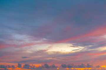 Vivid orange sky and glowing twilight clouds at sunset create a tranquil evening mood.