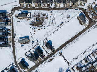 Snow covered neighborhood with houses and a road