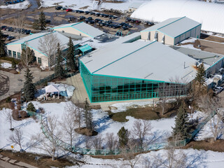 Large building with a green roof and a large glass window