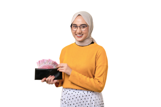 Beautiful smiling Asian girl wearing hijab holding wallet full of money with happy face isolated on transparent background