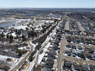 Snowy cityscape with houses and a road