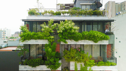 Green architectural design showcasing vertical gardens climbing building facades, integrating...