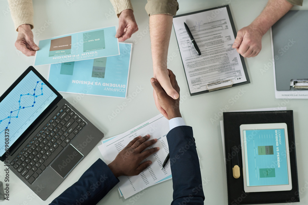 Aufkleber top view of financial agent shaking hands with senior people while they sitting at table and applyin