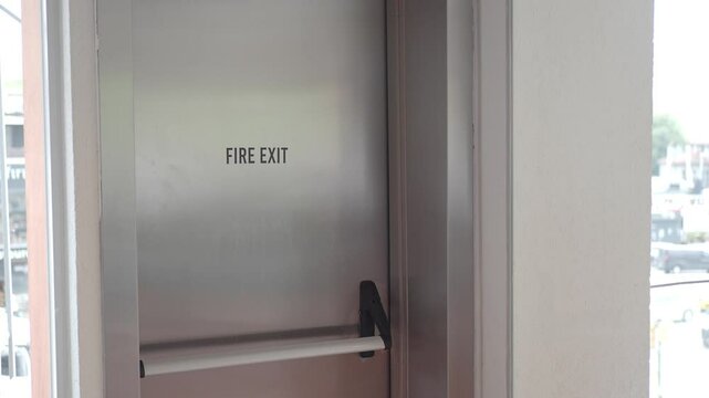 Fire exit door located in a bright urban building area