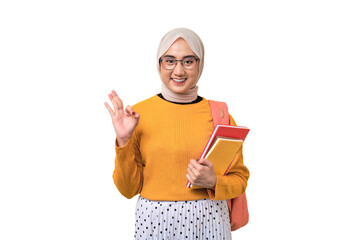 Smiling young Asian student girl with backpack holding notebook, doing ok sign with finger isolated on transparent background