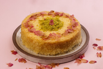 Kunafa is Arabic Traditional Desserts in a Plate With Pistachio and Roses Petal.
