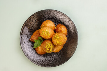Luqaimat or Awameh is a Sweet Doughnut Ball Dessert from Middle Eastern Countries, Popular as a Ramadan Dessert.