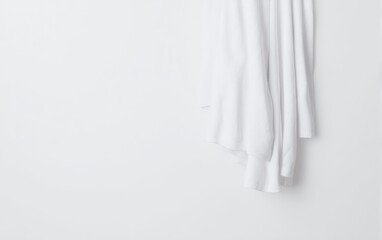 Fototapeta premium A white towel is hanging on a wall beside a toilet in a bathroom setting, Hello Summer background.