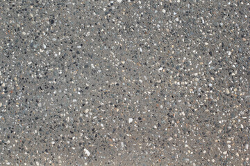 Light grey gray concrete surface with exposed aggregate stones textured background