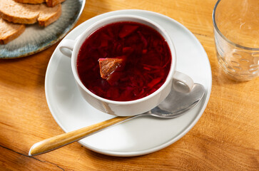 Appetizing shchi soup with beef broth and sauerkraut served in bowl