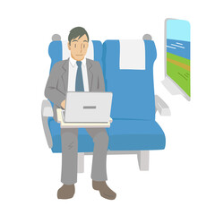 新幹線の座席で報告書を作成するビジネスマン