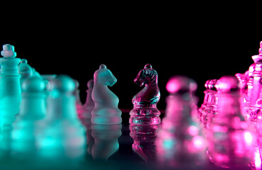two glass chess knights facing each other © Jeffrey