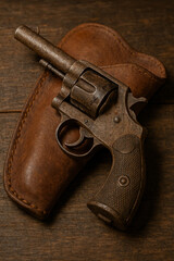 A well-worn six-shooter placed carefully on a rustic leather holster, with the faint texture of the wood and metal clearly visible in warm, natural light