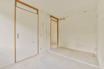 A spacious, empty room featuring clean lines, white walls, and a light floor, perfect for creating...