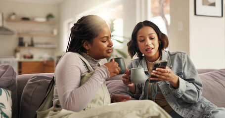 Bonding, friends and women with smartphone, coffee and showing message on social media, smile or home. Relax, browsing and people with mobile for chat, happy or girls with hot beverage in living room