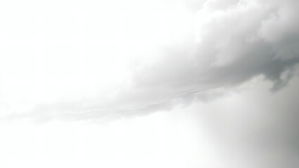 Fototapeta premium Overcast skies with clouds drifting by, painting a monochrome landscape with shades of gray against a luminous white.