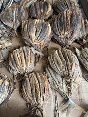 A pile of dried fish is displayed on a table
