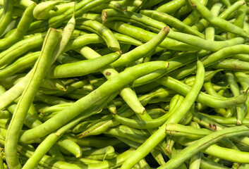 A bunch of green beans are piled on top of each other