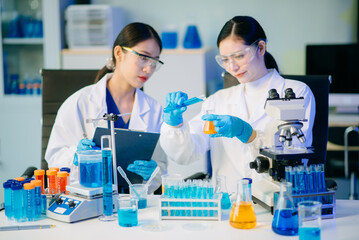 Biologist taking experiment with plants working in biochemistry laboratory.