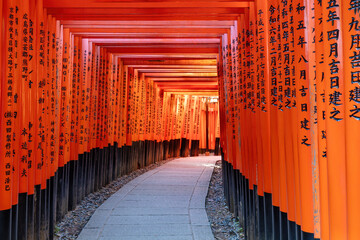 Orange wooden gates of Fushimi Inari Shrine, in Kyoto, Japan. 
