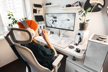 Side view of gamer interacting with a dynamic gaming environment. High-fidelity display, crisp audio, and responsive controls combine for fully immersive gaming experience. Girl drinks energy drink © Aboltin