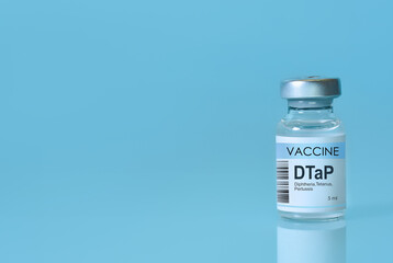 DTaP vaccine bottle labeled for diphtheria, tetanus, and pertussis on a clean blue background....