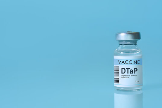 DTaP vaccine bottle labeled for diphtheria, tetanus, and pertussis on a clean blue background. Concept of immunization, medical science, disease prevention, healthcare awareness. Copy space. Banner