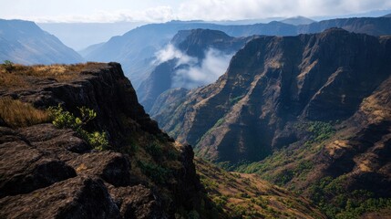 Fototapeta premium Mountain cliff edge view of valley with mist
