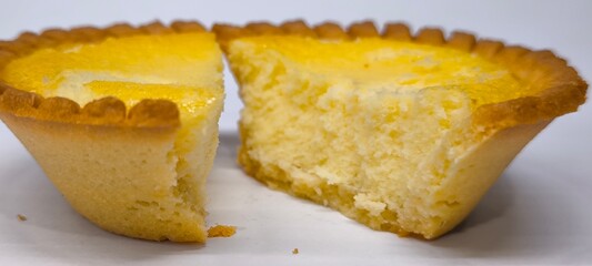 Egg tarts that are crispy on the outside and soft on the inside. Egg tarts that have a rich and creamy egg aroma. Egg tarts on white background.