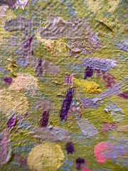 Multicolored chaotic strokes of oil paint on rough canvas. In pastel soft purple tones. Close-up. Selective focus.
