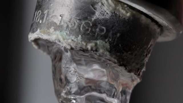 Hard Water Problems: Water Flowing from Tap Close Up